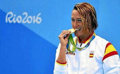 Mireia Belmonte muerde su medalla de oro olímpica en 200 mariposa. Mireia Belmonte muerde su medalla de oro olímpica en 200 mariposa.